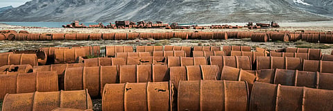 
Rusting fuel drums and vehicles remain at an abandoned U.S. World War II base in Greenland. 