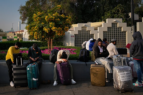Passengers stranded by the closure of Dubai International Airport await for assistance in the airport parking lot in Dubai, United Arab Emirates on March 1, 2026.