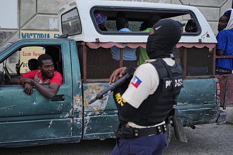 A police officer stands guard in Port-au-Prince, Haiti, Tuesday, March 3, 2026. 
