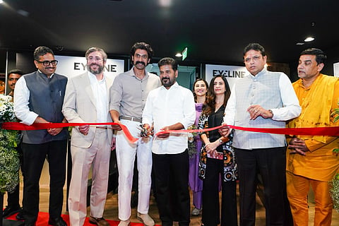 An image showing a group of prominent figures at a ribbon-cutting ceremony for the inauguration of Eyeline Studios (a Netflix company) in Hyderabad.

Centrally located, Revanth Reddy (Chief Minister of Telangana) is seen cutting a bright red ribbon with a pair of scissors. He is flanked by actor Rana Daggubati to his right and other dignitaries and executives on both sides. The background features the "EYELINE" logo on the walls. The atmosphere is professional and celebratory, with several attendees smiling as the ribbon is cut.