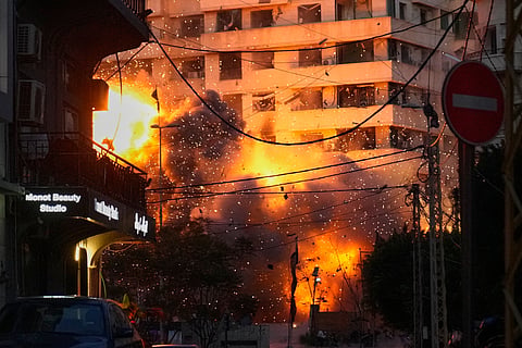 An explosion erupts from a building following an Israeli strike in central Beirut, Lebanon, Wednesday, March 18, 2026.
