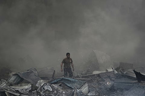 A first responder emerges through the smoke at the site of an Israeli airstrike that struck an apartment building in Beirut, Lebanon, Wednesday, April 8, 2026. (AP Photo/Bilal Hussein)

