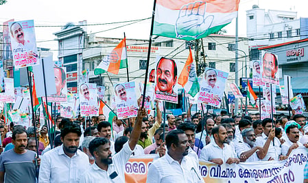 Supporters of VD Satheesan march through Kerala carrying Congress flags