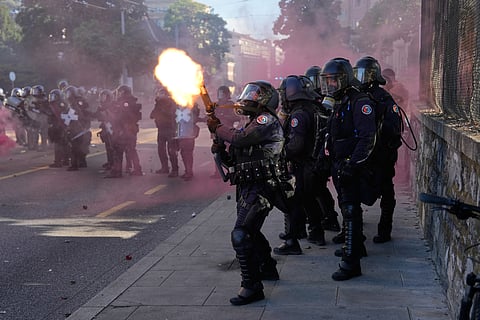 Police fire a tear gas canister during a "No G7" demonstration in Geneva, Switzerland, Sunday, June 14, 2026, ahead of the G7 summit scheduled to take place June 15-17. 