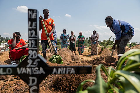 Red Cross workers prepare to bury Vanisa Anifa, a 6-month-old orphaned girl who died of Ebola, at the Bigo Cemetery, in Bunia, Congo, Friday, June 19, 2026. 