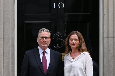 Britain's Prime Minister Keir Starmer and wife Victoria stand in front of 10 Downing Street door after after announcing his resignation in London, Monday, June 22, 2026.