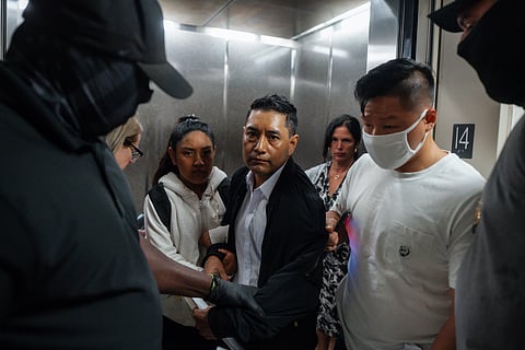 Immigration and Customs Enforcement agents pull a man out of an elevator as he and his daughter attempt to leave following a hearing in immigration court, Friday, Sept. 5, 2025, in New York. 