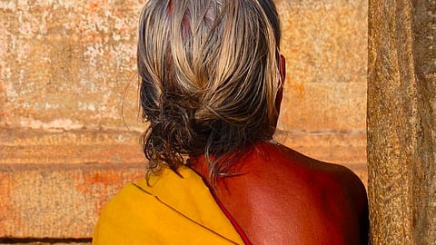 An old woman with her back to the camera, image used for representation 
