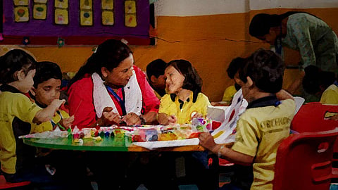 A stylised image of a teacher sitting with students in a classroom