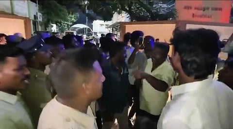 Protestors arguing with police officers, accusing them of failing to act immediately against those allegedly involved in the assault.
