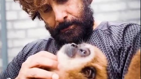 Actor Vikram interacting with a lar gibbon