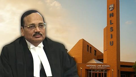 A picture of a slightly balding man with spectacles and a moustache, dressed in black advocates' gown, against a backdrop of a reddish coloured building with a tower with the initials NLSIU vertically written. 
