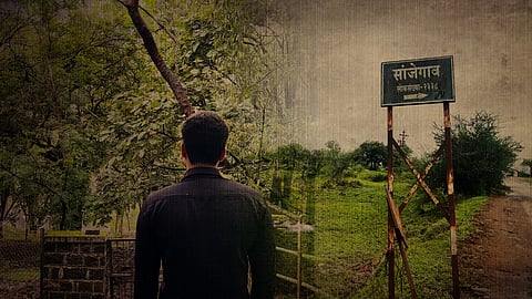 A man stands near the entrance to Sanjegaon, where questions over Gita Govardhane’s death have left the village tense and silent.