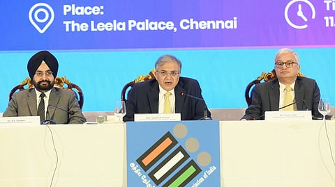 Chief Election Commissioner Gyanesh Kumar is seen talking over a mic. Election Commissioners Sukhbir Singh Sandhu is seen on the left and Vivek Joshi on the right. All three sitting, as if they are attending a conference. 