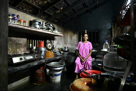 Still from the film, of a woman in her kitchen, flooded with saline water