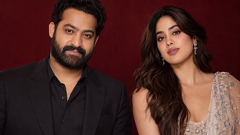 Jr NTR, Janhvi Kapoor against a deep maroon background
