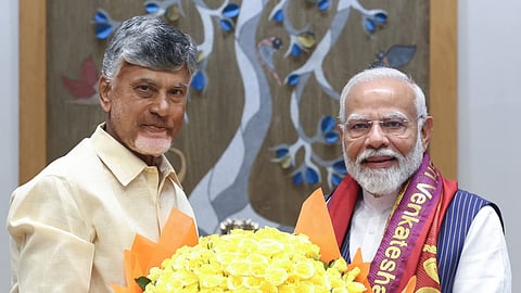 N. Chandrababu Naidu presenting a large bouquet of yellow roses to Prime Minister Narendra Modi.   