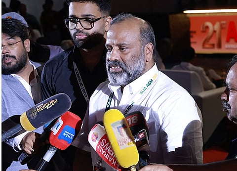 R Premkumar speaking in front of a bunch of mikes of Malayalam news channels