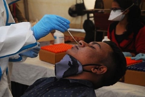 A healthcare professional collecting nasal sample for RT-PCR test