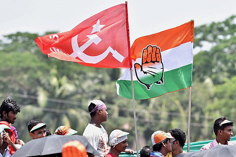 Flags of CPIM and Congress being waived at a rally