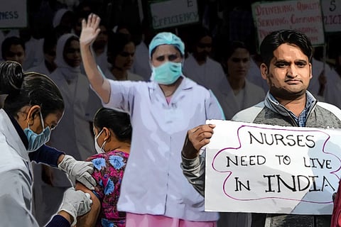 A posterised image of a nurse protesting, a male nurse holding a placard that says "Nurses need to live in India" and another nurse administering injection to a patient. 