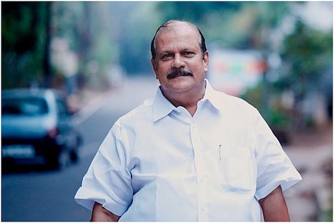 PC George wearing a white shirt