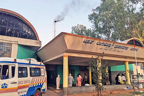 An ambulance waits in the corner at the Panathur crematorium 