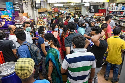 People outside a shop panic buying during Covid-19 induced lockdown fearing shortage of essential commodities 