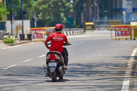 Zomato delivery executive riding a bike on the road