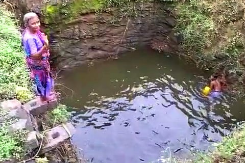 Swimmer Papa is seen standing on the top before jumping into the well. 