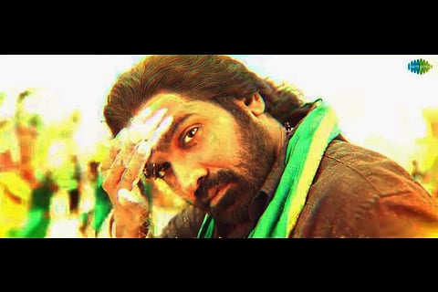 Vijay sethupathi donning a black shirt and veshti and seen as a devotee.