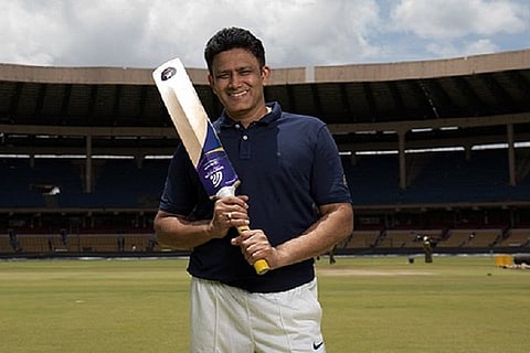 Anil KUmble standing with bt in his hand