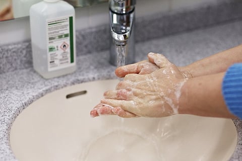 A person washing hands