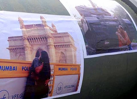 Seeing people kiss in public is okay, but looking at posters of it is not?