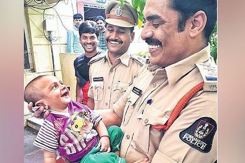'Best photo ever': Photo of rescued baby's toothless grin at Hyderabad cop is melting hearts