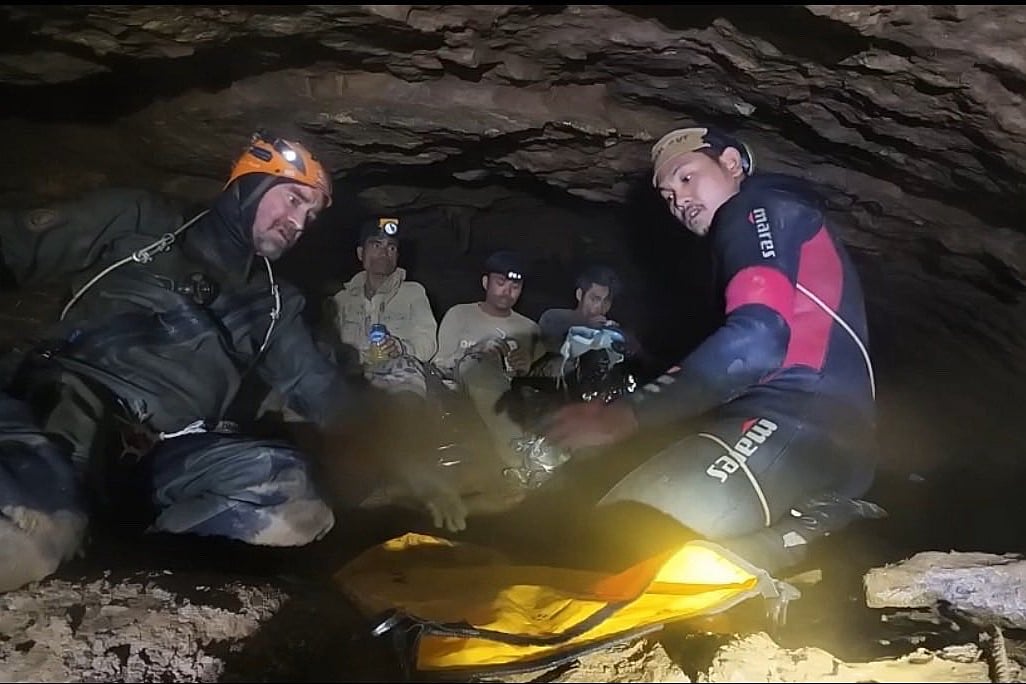 Rescuers free 4 men who had been trapped in a flooded Laos cave, search for 2 still missing