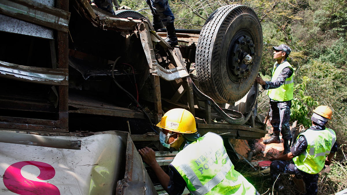 File photo: Rescue workers search for victims at the site of a bus accident. (Photo: AP/Niranjan Shrestha)