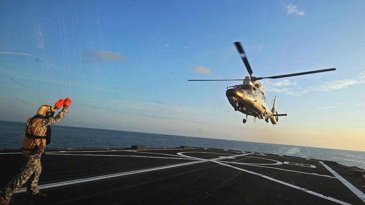 A Dolphin Z-9 helicopter of China’s Navy missile frigate CNS Yulin flies off the deck of Singapore’s Navy missile frigate RSS Intrepid during the “Exercise Maritime Cooperation 2015” by Singapore and Chinese navies in the South China Sea.’ (Photo: AP)