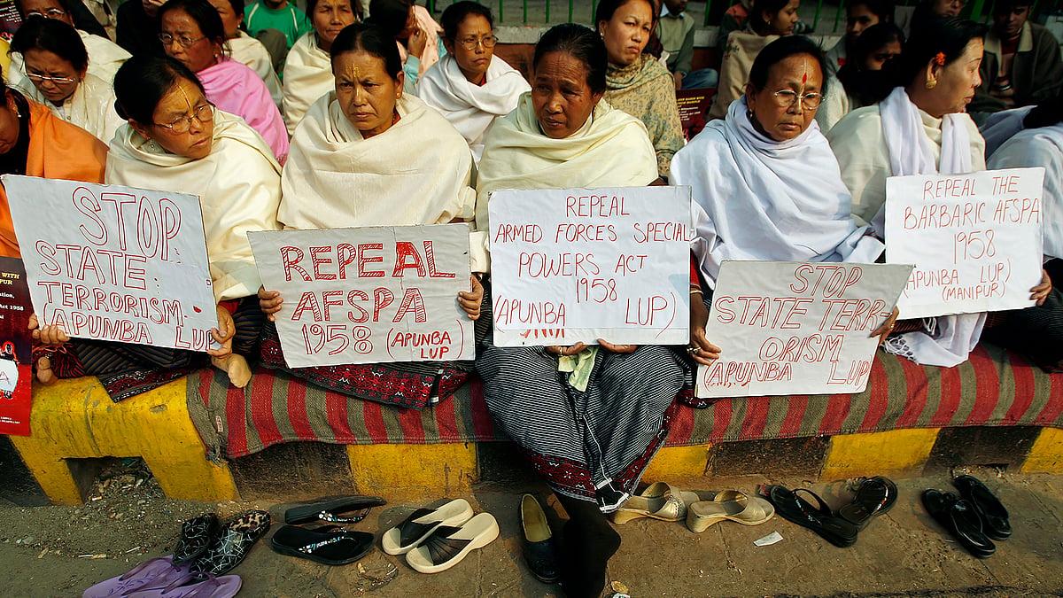 Women hold placards during a protest against the Armed Forces Special Powers Act (AFSPA).