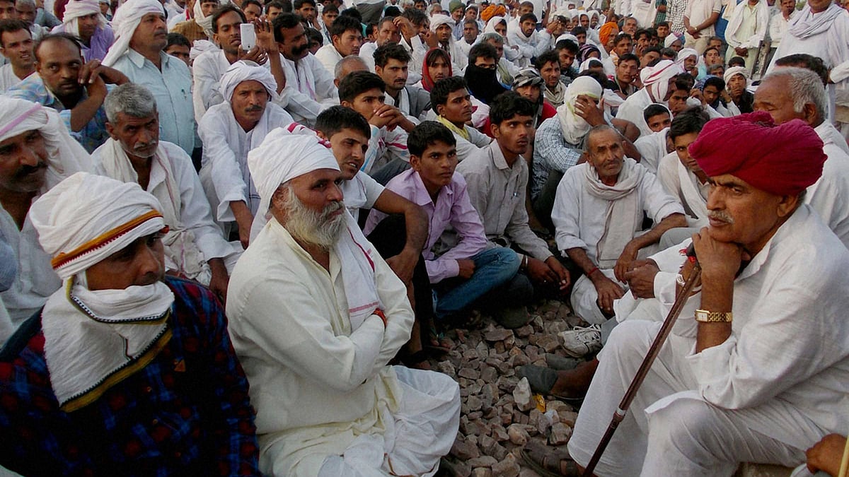 Gujjar leader Kirori Singh Bainsla (R) leads a protest for reservation in government jobs and educational institutions on the Delhi-Mumbai railway track. (Photo: PTI)