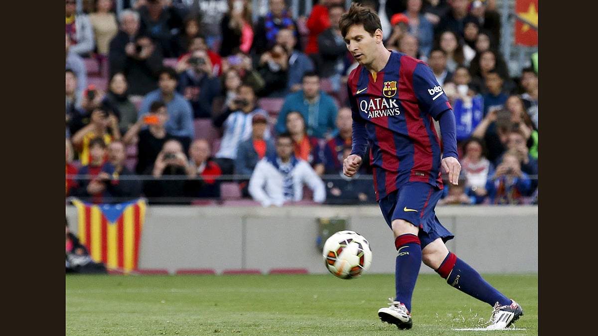 Barcelona’s Lionel Messi scores his penalty goal against Getafe during their Spanish first division soccer match at Nou Camp stadium in Barcelona. (Photo: Reuters) 