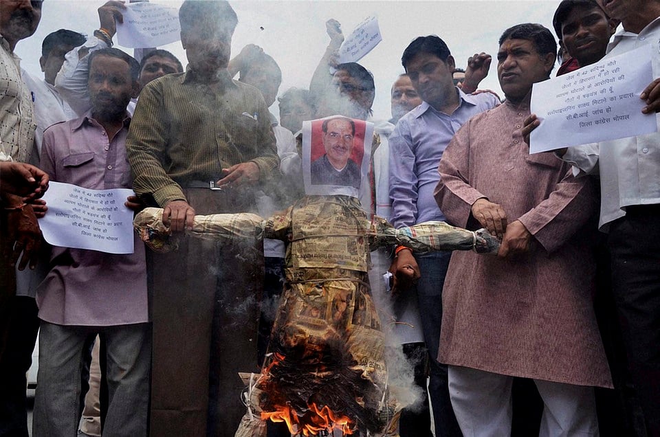 Congress activists burning an effigy of Madhya Pradesh Chief Minister Shivraj Singh Chouhan in Bhopal. (Photo: PTI) 