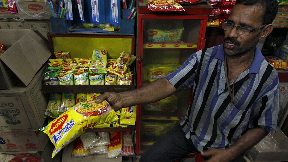 A vendor hands out a packet of Maggi noodles. (Photo: Reuters)