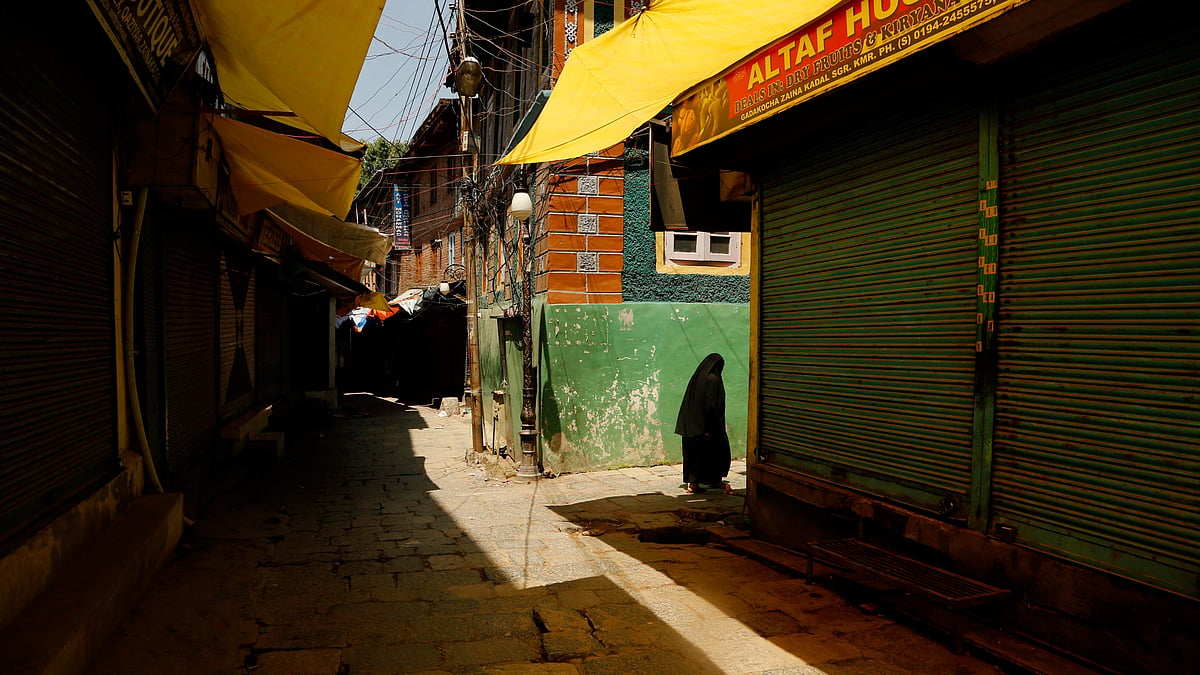 A Kashmiri woman walks through a closed market during a strike in Srinagar. (Photo: AP)