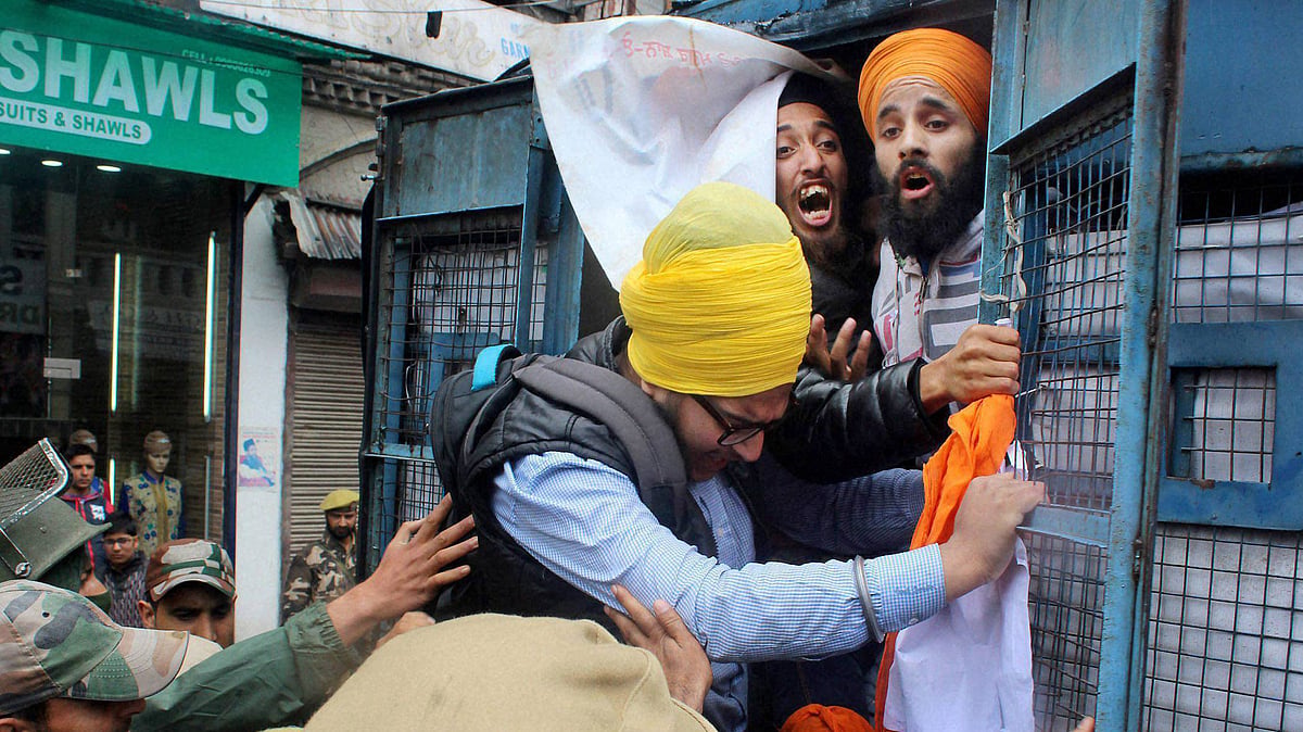 Police take Sikh youth into custody. (Photo: PTI)