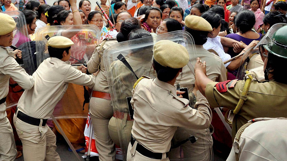 Police personnel try to stop demonstrators during a protest rally in Manipur. (Photo: PTI)