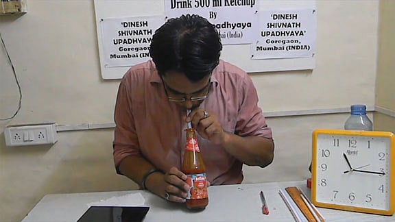 Dinesh Upadhyay gulps down a bottle of ketchup in a record breaking 30 seconds. (Photo: AP screengrab)