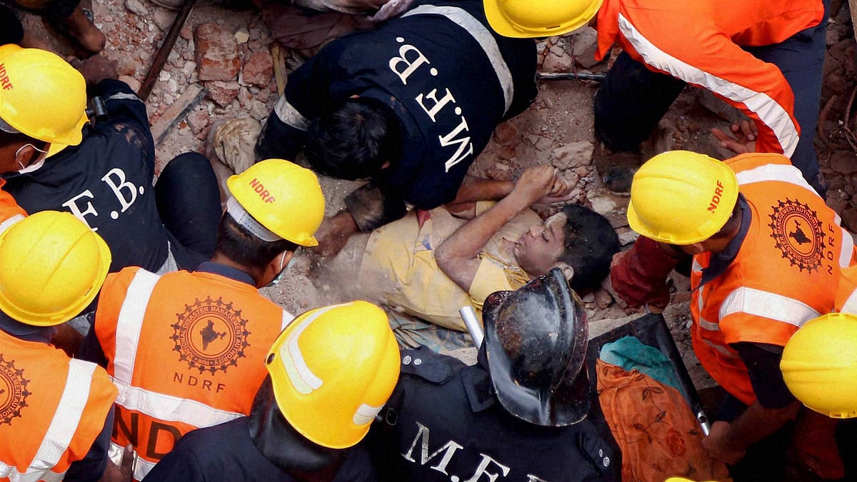 Rescue personnel save a person from the third floor of the collapsed building in Thane. (Photo: PTI)