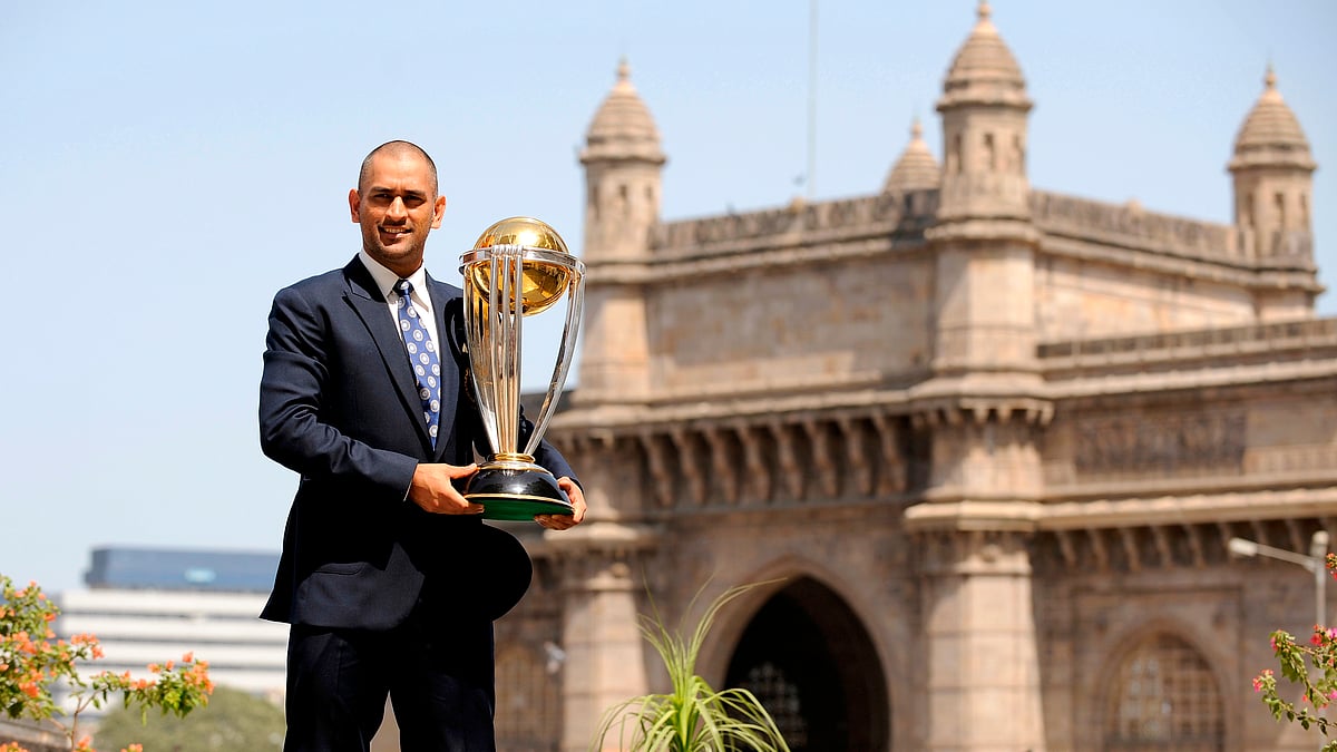 Mahendra Singh Dhoni poses with the World Cup trophy a day after winning the 2011 World Cup in Mumbai (Photo: Reuters)