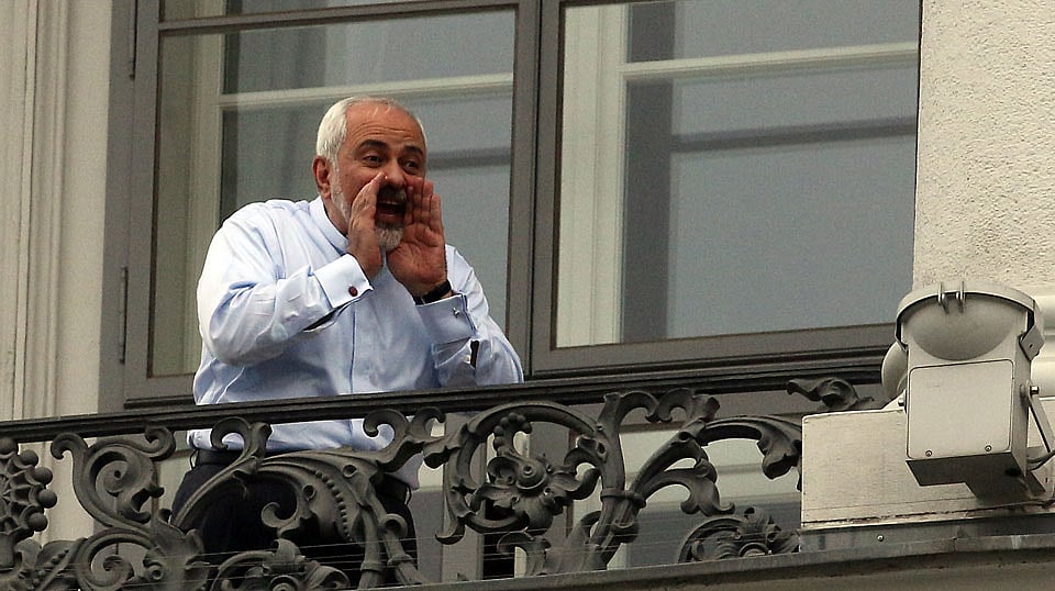 Iranian Foreign Minister Mohammad Javad Zarif talks to journalist from a balcony of the Palais Coburg where closed-door nuclear talks with Iran continue in Vienna, Austria. (Photo: AP)